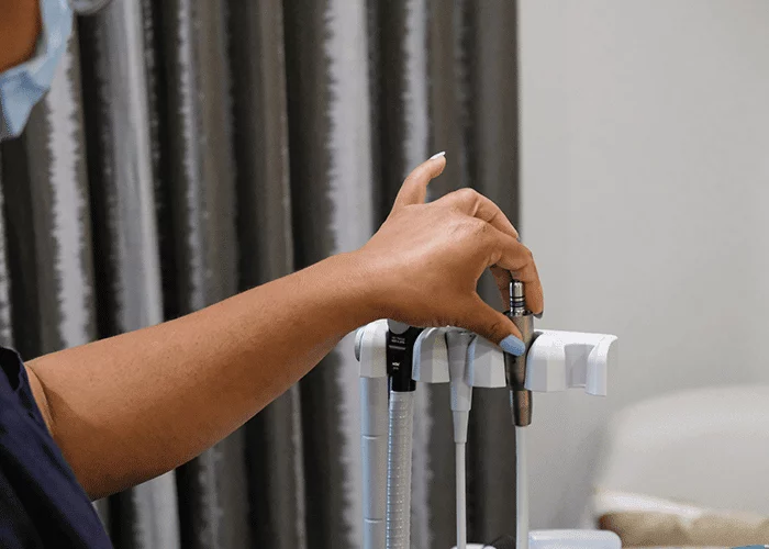 The dental assistant setting up the mobile dental unit